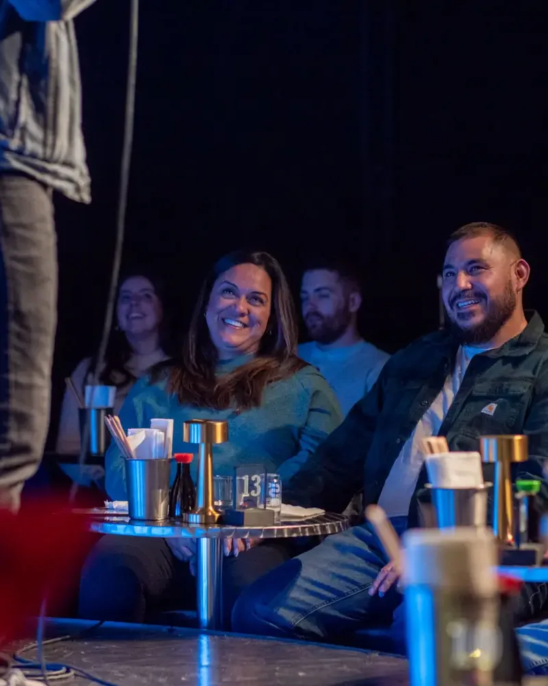 Couple laughing at Denver Comedy Lounge — the perfect date night