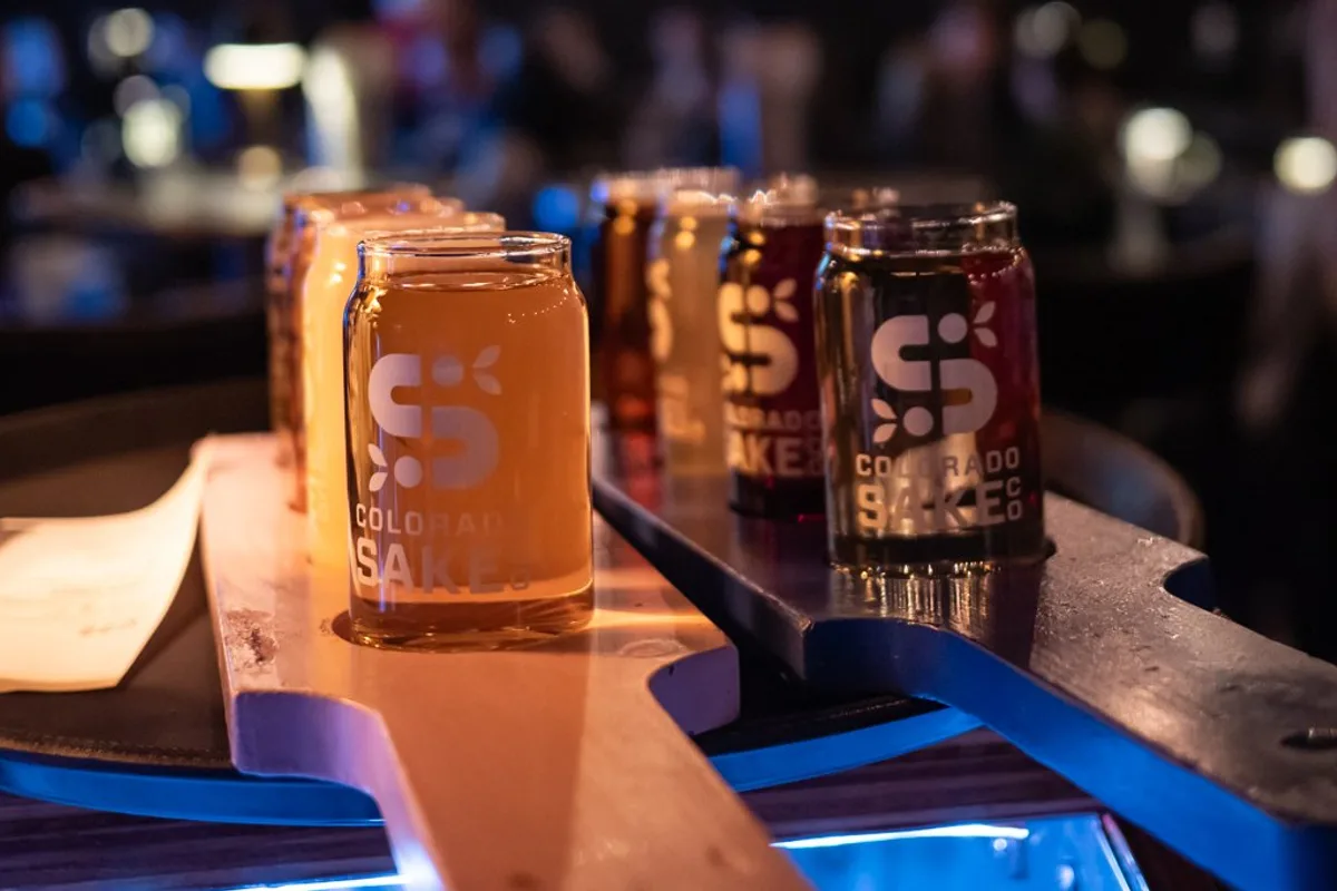 Colorado Sake Co. sake flight — four craft sakes on wooden paddle