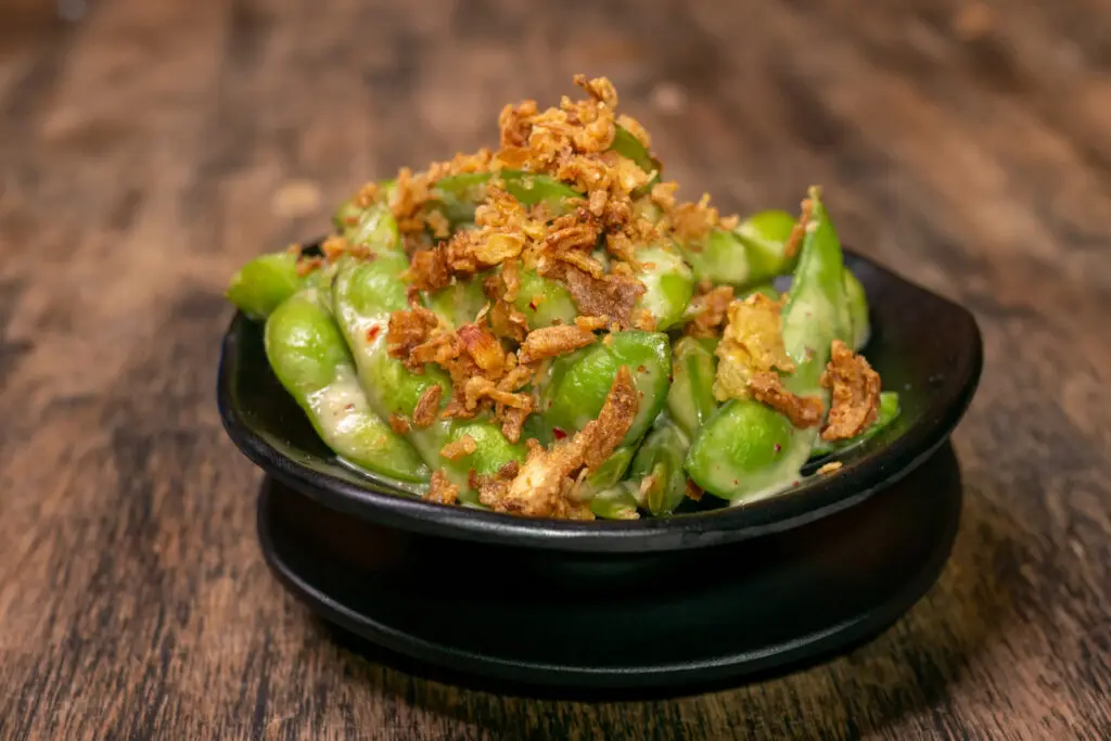 a bowl of edamame on a table