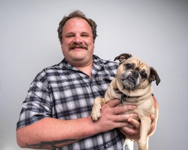 Award winning comedian Sam Miller holding a cute puppy. Promoting his Stand-Up comedy show, Sam Miller Live In Denver January 30th at 7:00pm.